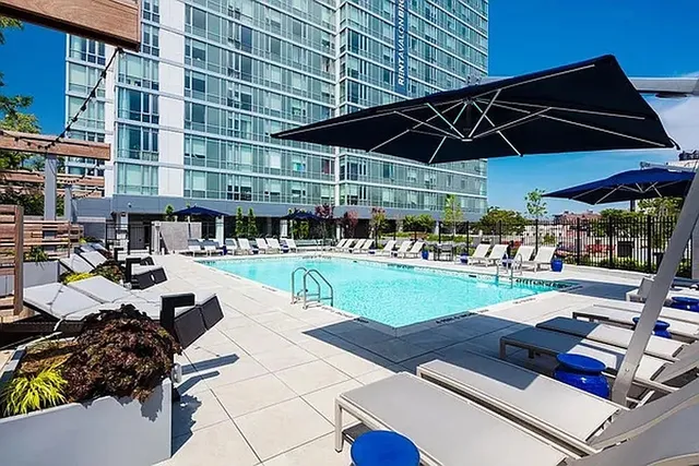 a swimming pool with outdoor seating and yard