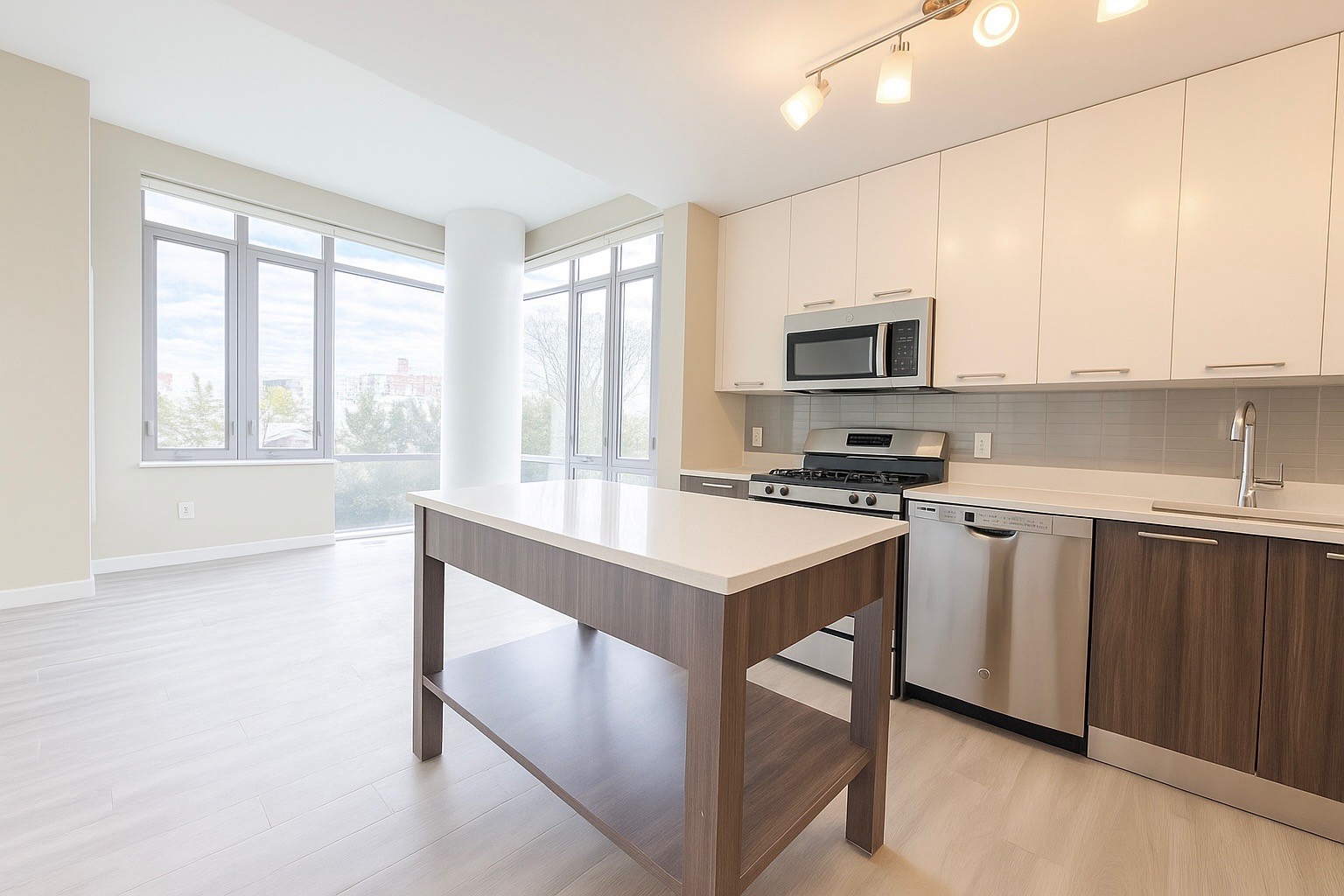 1524 Sheepshead Bay Road, Unit 3C Brooklyn, NY 11235 - Photo 4 of 25 a kitchen with stainless steel appliances granite countertop a stove a sink and a microwave