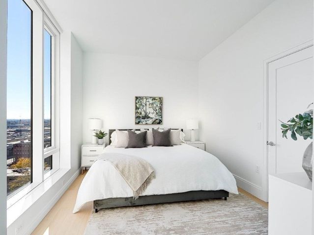 a bedroom with a bed and a potted plant