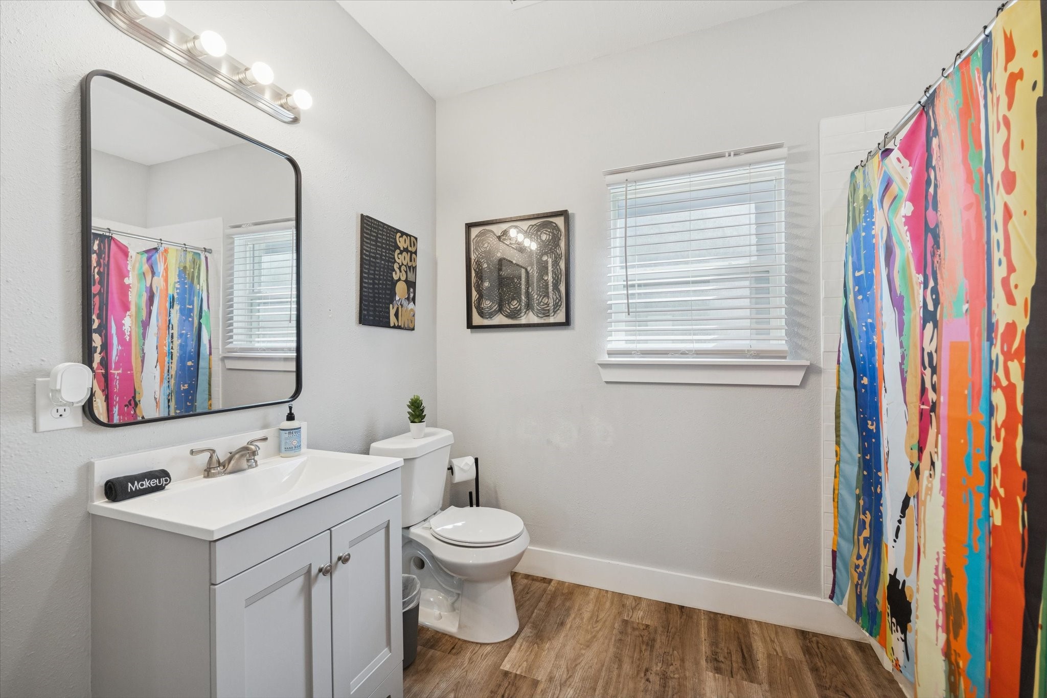 2410 Truxillo Street Houston, TX 77004 - Photo 12 of 41 Unit A (2-Bedroom): Full bathroom with updated vanity, framed mirror, bright lighting, and tub/shower combination with window for natural light.