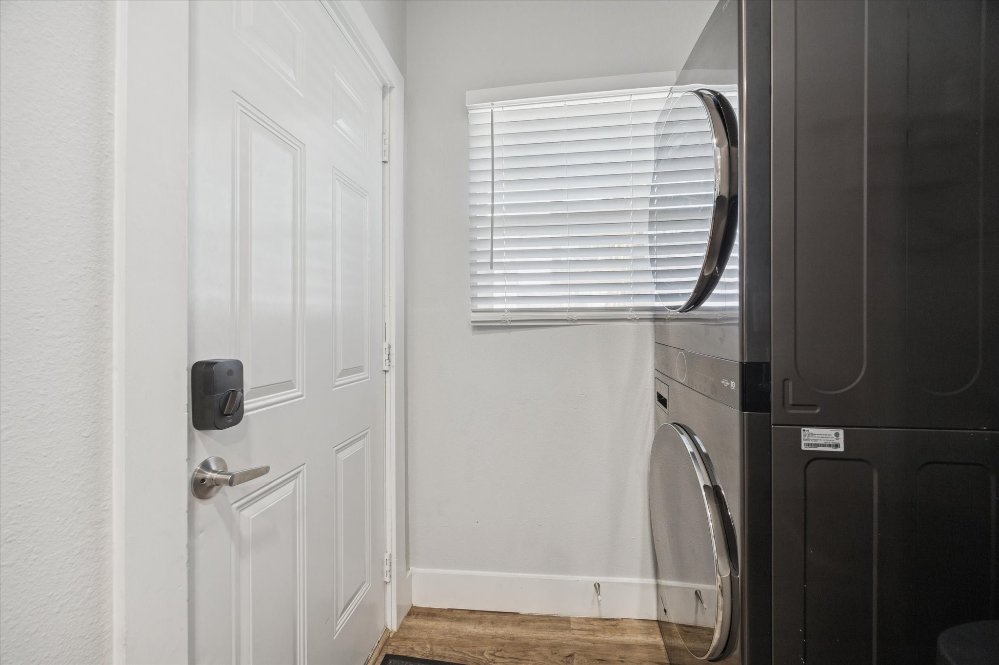 2410 Truxillo Street Houston, TX 77004 - Photo 14 of 41 Unit A (2-Bedroom): In-unit laundry area with stacked washer and dryer conveniently positioned near the entry for everyday ease.