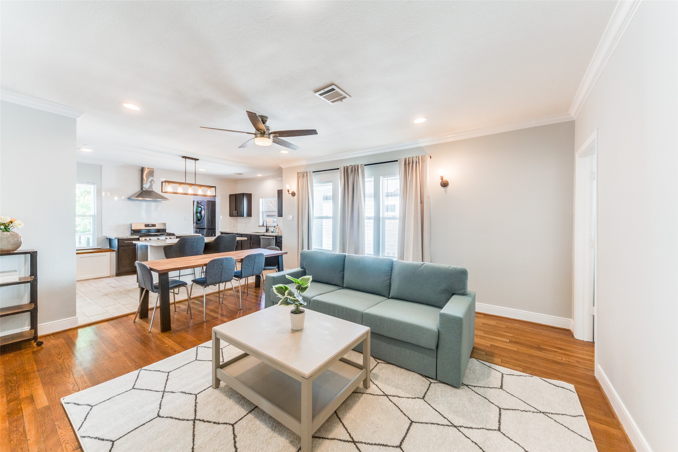 2410 Truxillo Street Houston, TX 77004 - Photo 15 of 41 Unit B (3-bedroom): Inviting open-concept living and dining area featuring warm hardwood flooring, recessed lighting, and an easy flow into the kitchen — perfect for comfortable everyday living.