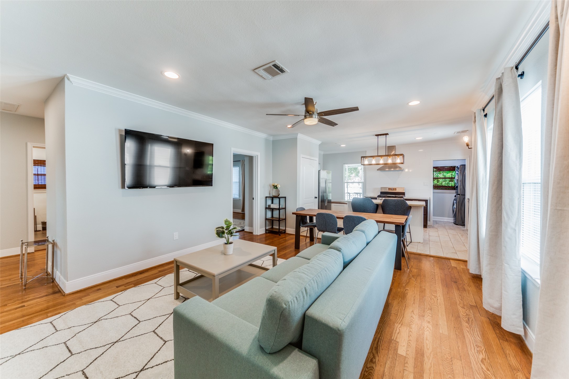 2410 Truxillo Street Houston, TX 77004 - Photo 16 of 41 Unit B (3-bedroom): Spacious living area with large windows, crown molding, and ceiling fan creating a bright and welcoming atmosphere for relaxing or entertaining.