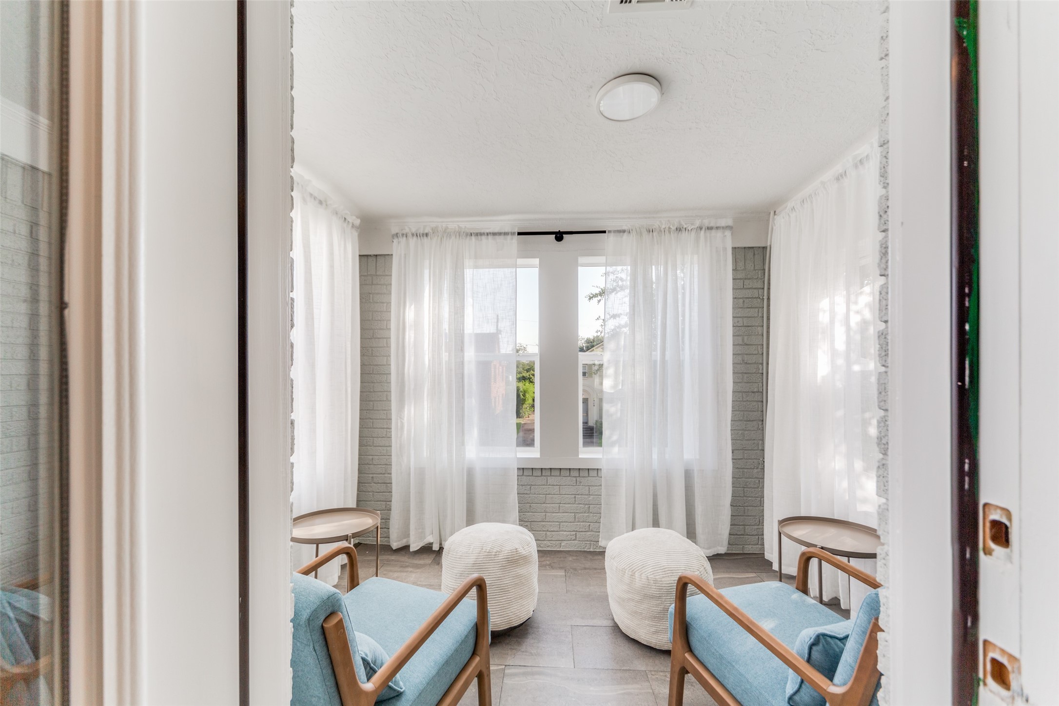 2410 Truxillo Street Houston, TX 77004 - Photo 25 of 41 Unit B (3-bedroom): Bright enclosed sunroom featuring expansive windows and light-filled ambiance — perfect for morning coffee, plants, or additional lounge space.