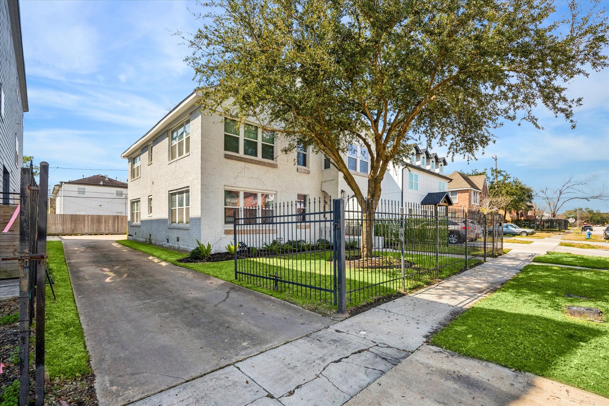2410 Truxillo Street Houston, TX 77004 - Photo 3 of 41 Corner perspective highlights the property’s generous footprint, gated yard space, and private driveway access leading toward rear private parking.
