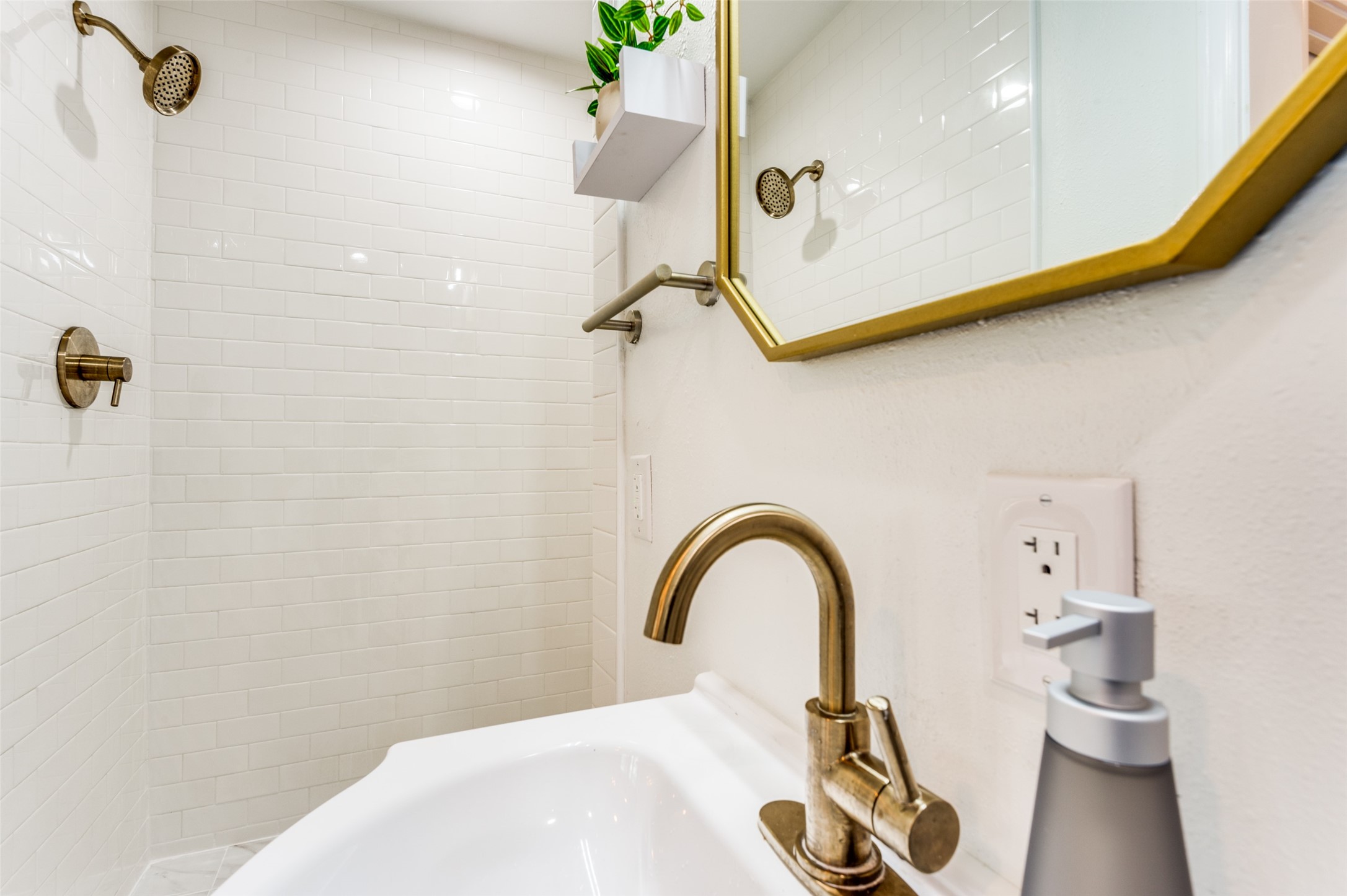 2410 Truxillo Street Houston, TX 77004 - Photo 35 of 41 Unit C (Studio): Updated bathroom featuring modern sink vanity, designer mirror, brushed gold fixtures, and walk-in shower with subway tile surround.