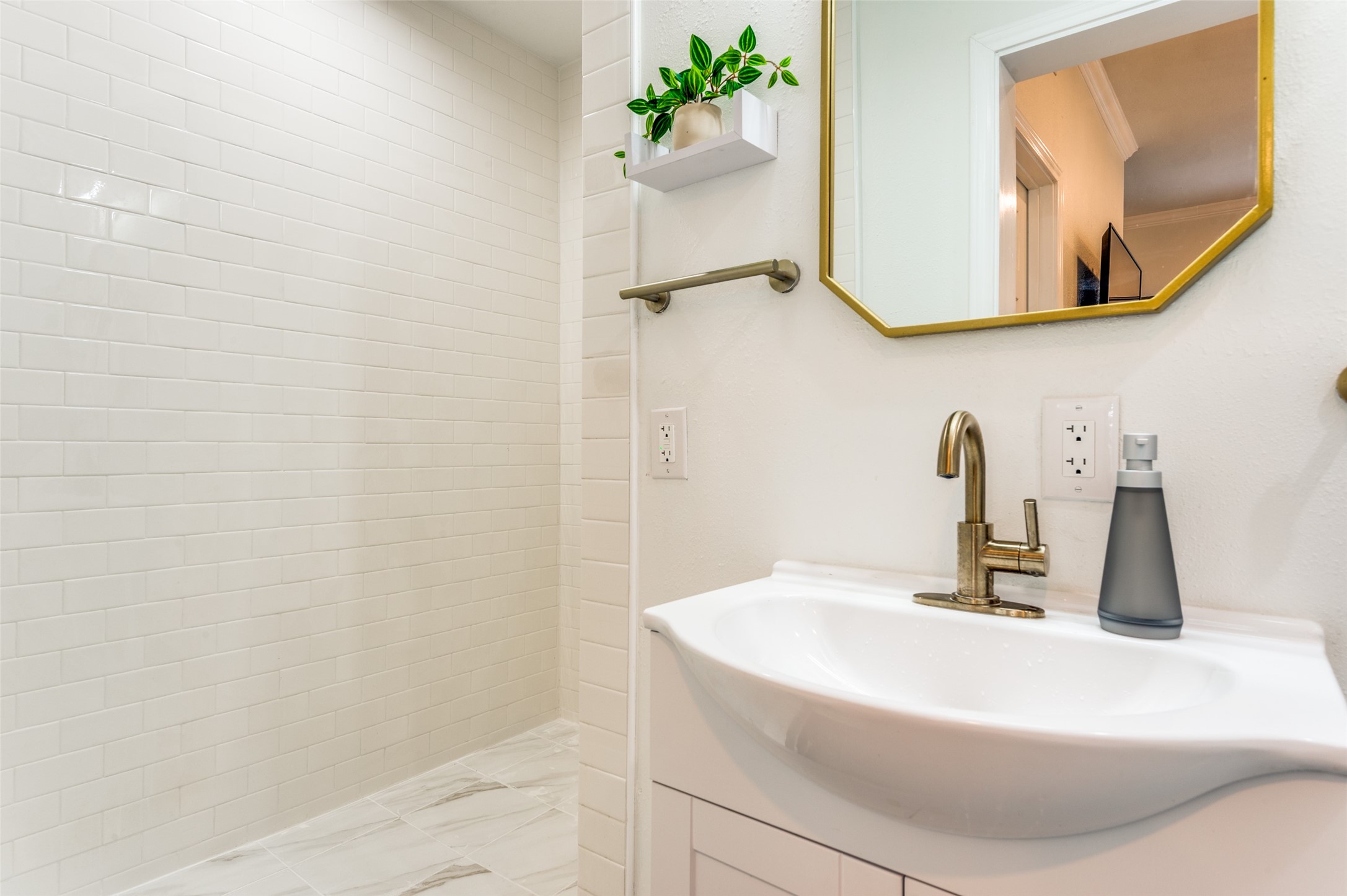 2410 Truxillo Street Houston, TX 77004 - Photo 36 of 41 Unit C (Studio): Updated bathroom featuring modern sink vanity, designer mirror, brushed gold fixtures, and walk-in shower with subway tile surround.