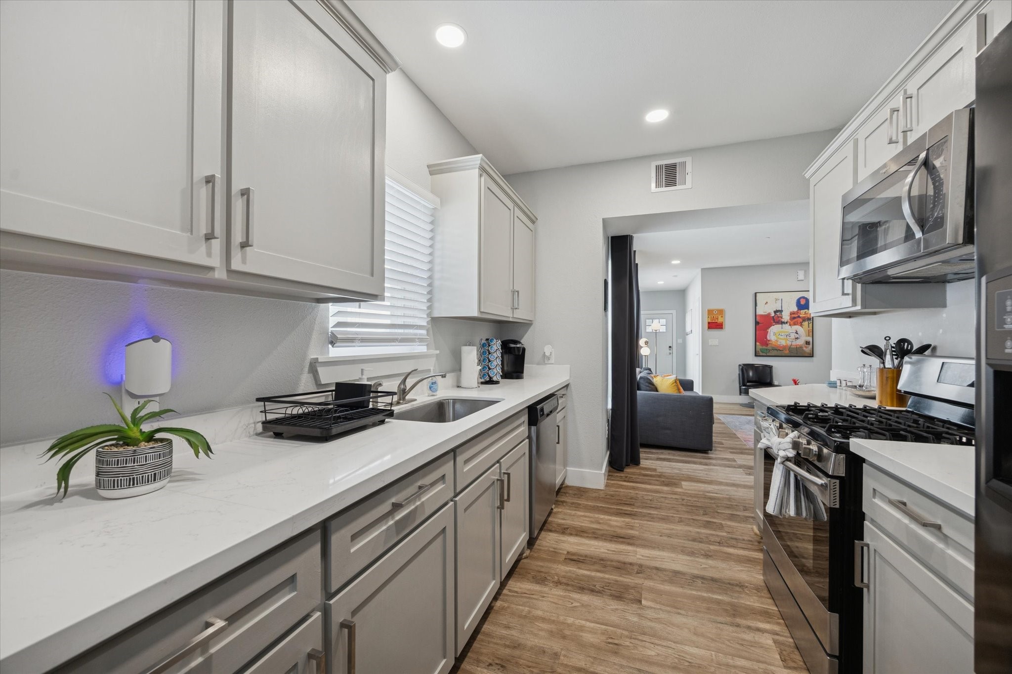 2410 Truxillo Street Houston, TX 77004 - Photo 9 of 41 Unit A (2-Bedroom): Well-appointed kitchen with ample prep space, stainless dishwasher, deep sink, and window providing natural light to the workspace.
