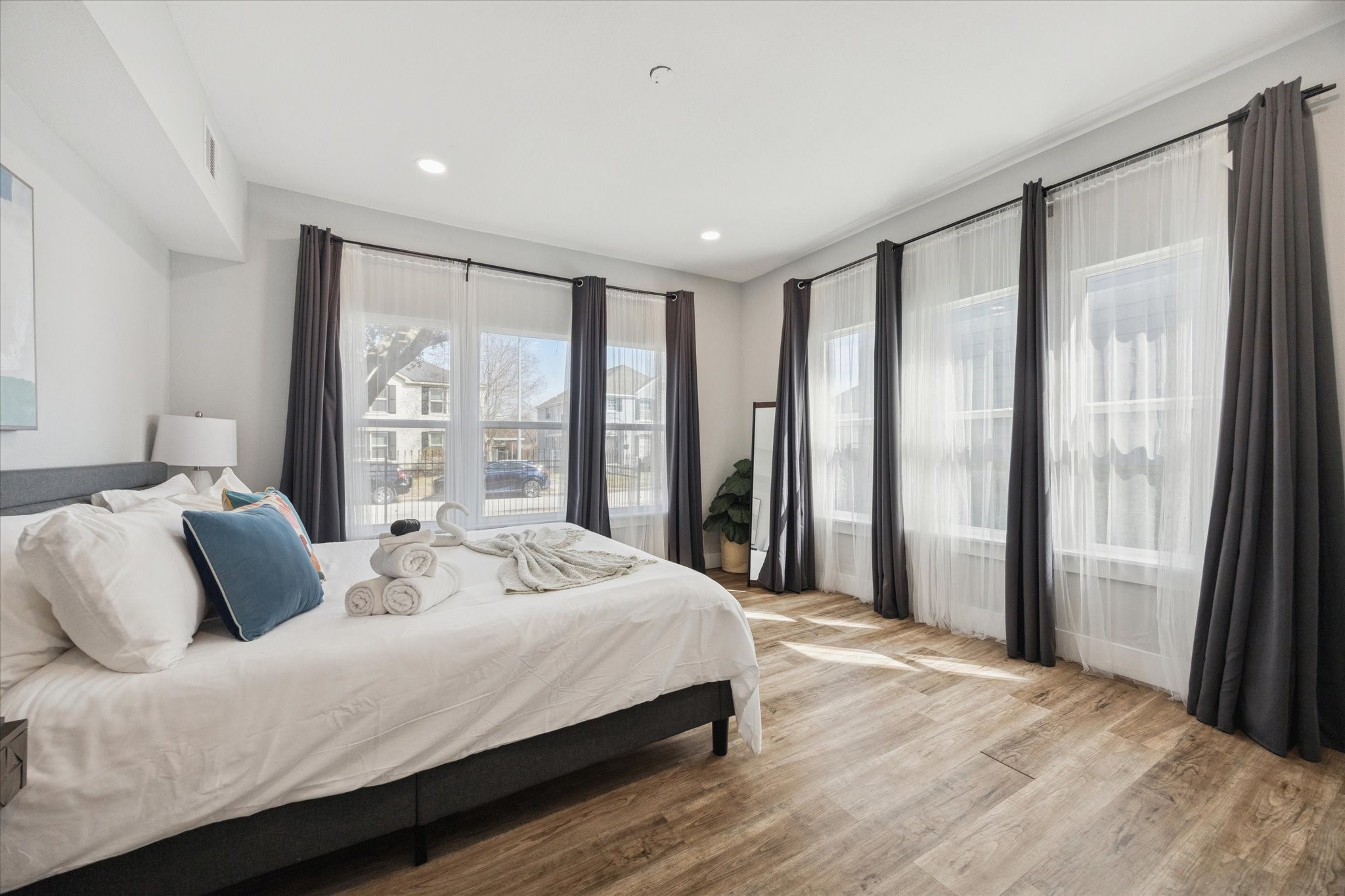 2410 Truxillo Street Houston, TX 77004 - Photo 10 of 41 Unit A (2-Bedroom): Expansive primary bedroom filled with natural light from multiple oversized windows, offering flexible layout options and a serene retreat.