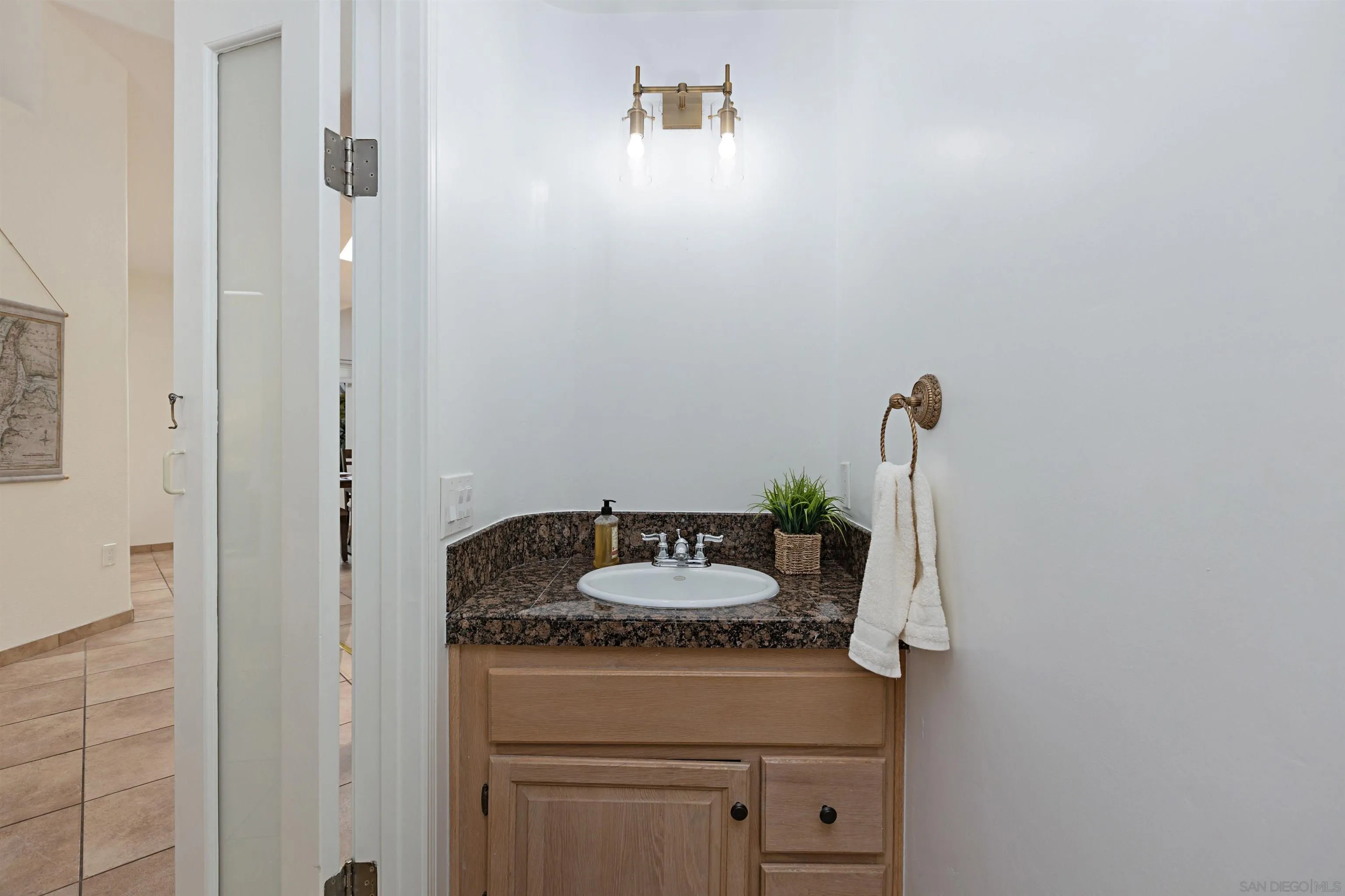 4158 Pindar Way Oceanside, CA 92056 - Photo 17 of 35 a bathroom with a granite countertop sink and a mirror