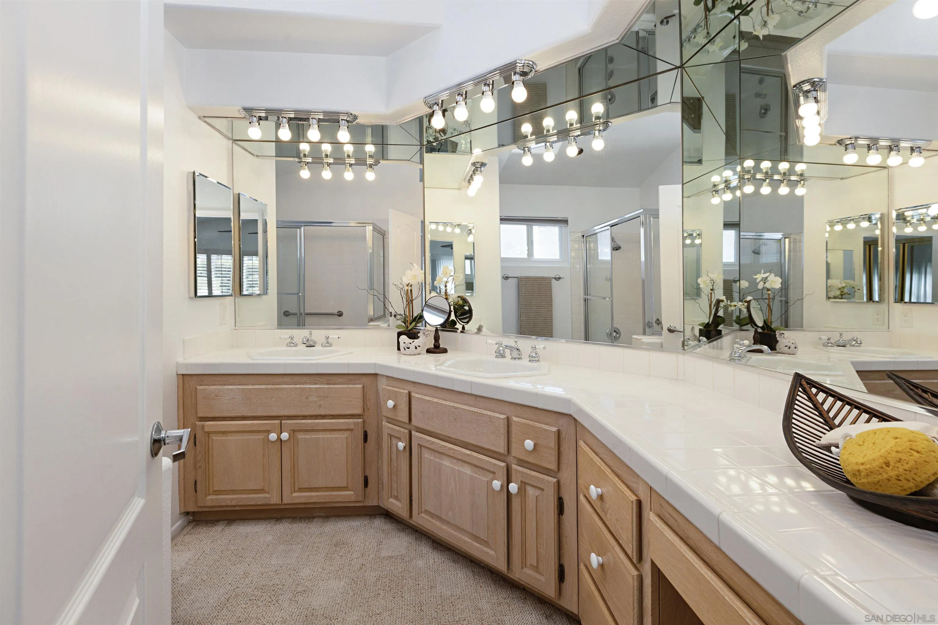 4158 Pindar Way Oceanside, CA 92056 - Photo 23 of 35 a spacious bathroom with a granite countertop sink a large mirror and a bathtub