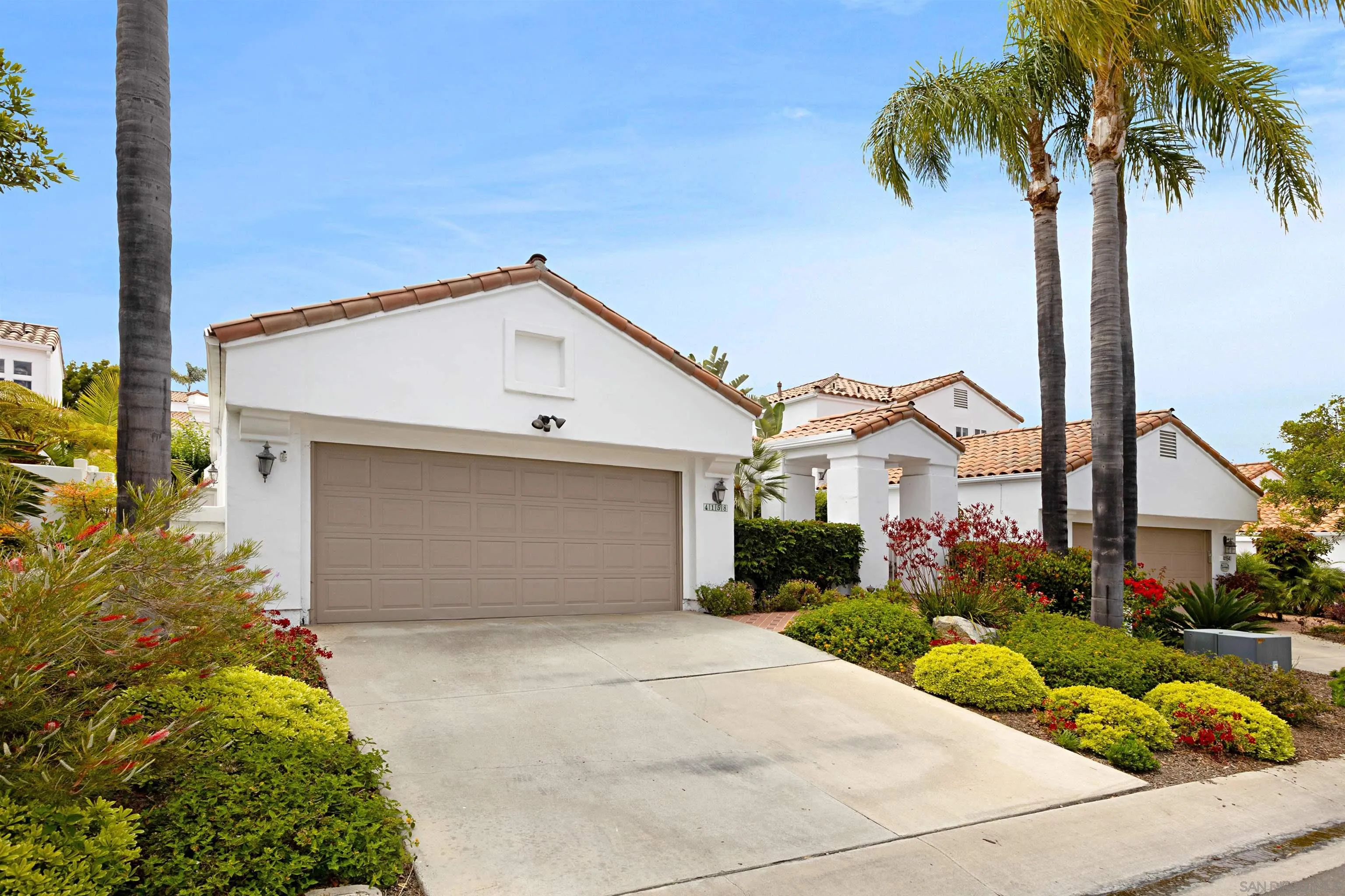 4158 Pindar Way Oceanside, CA 92056 - Photo 33 of 35 a front view of a house with a garden and garage