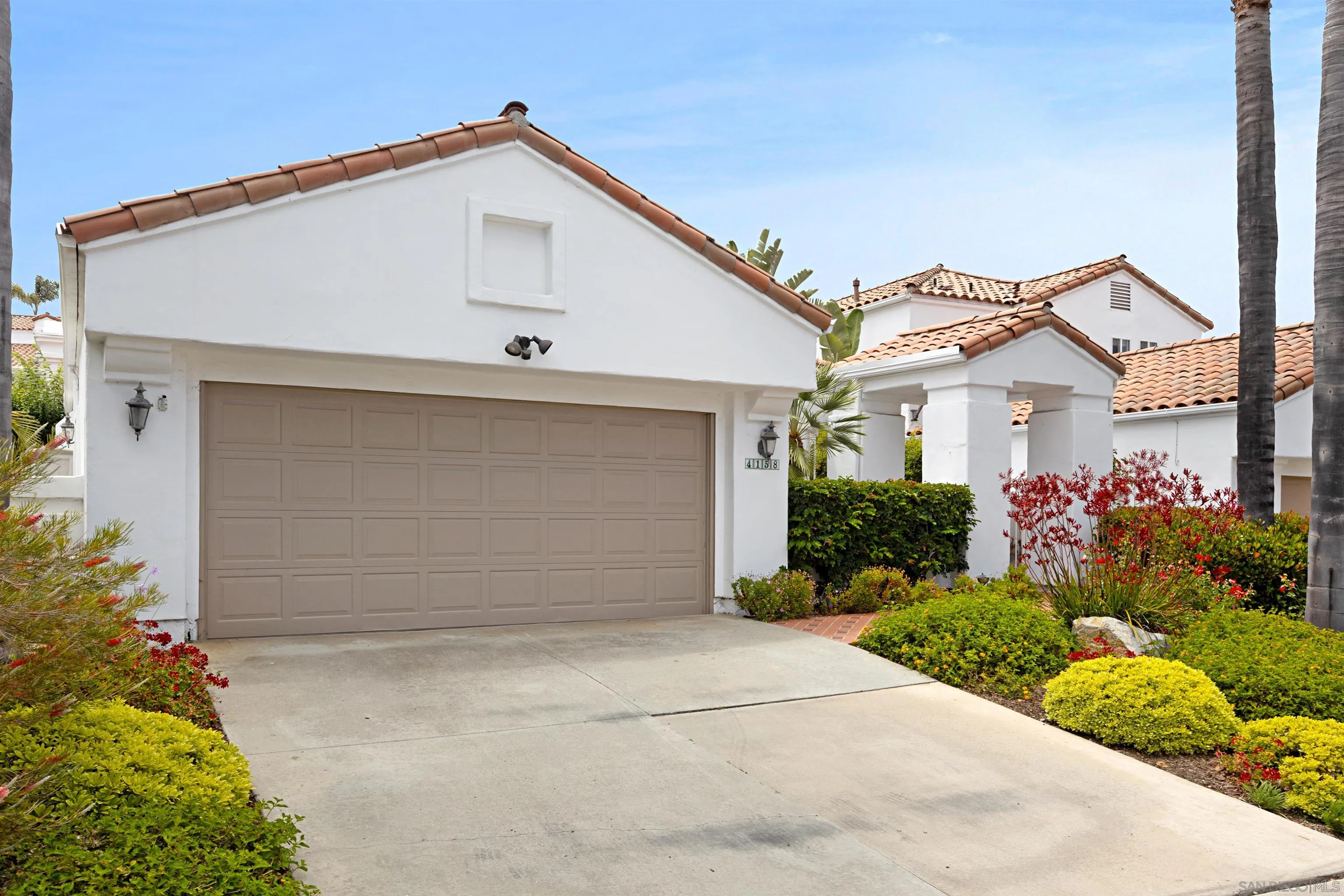 4158 Pindar Way Oceanside, CA 92056 - Photo 34 of 35 a front view of a house with a yard and garage