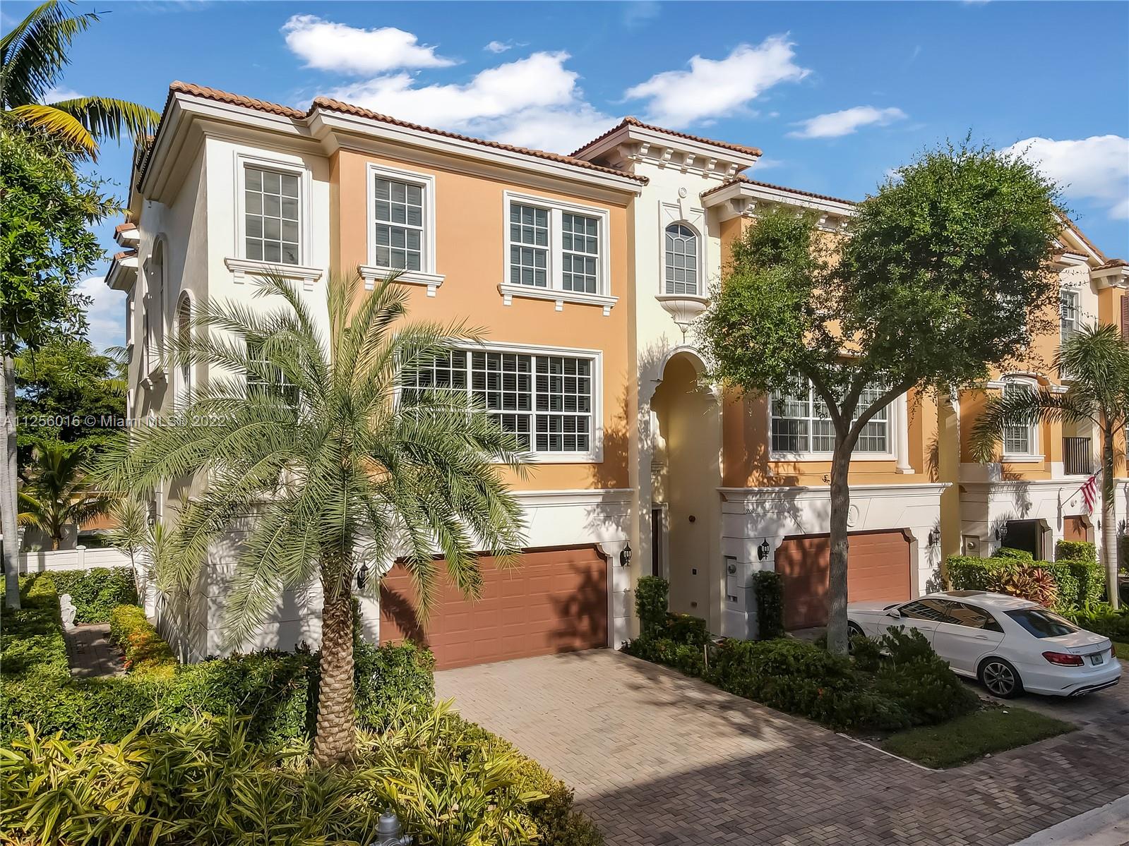 5560 Northeast Trieste Way Boca Raton, FL 33487 - Photo 3 of 28 a front view of a house with garden