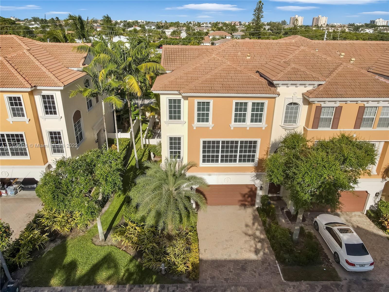 5560 Northeast Trieste Way Boca Raton, FL 33487 - Photo 4 of 28 front view of house with a yard