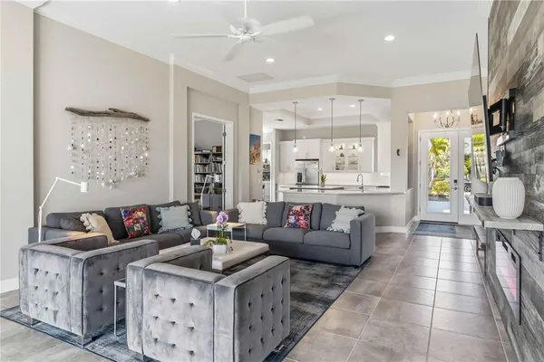 a kitchen with stainless steel appliances granite countertop a stove a sink a dining table and chairs with wooden floor