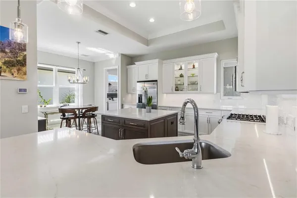 a kitchen with a white cabinets and window