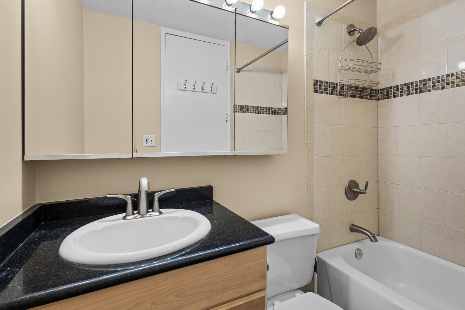 2728 North Hampden Court, Unit 109 Chicago, IL 60614 - Photo 11 of 20 a bathroom with a granite countertop sink a toilet and bathtub