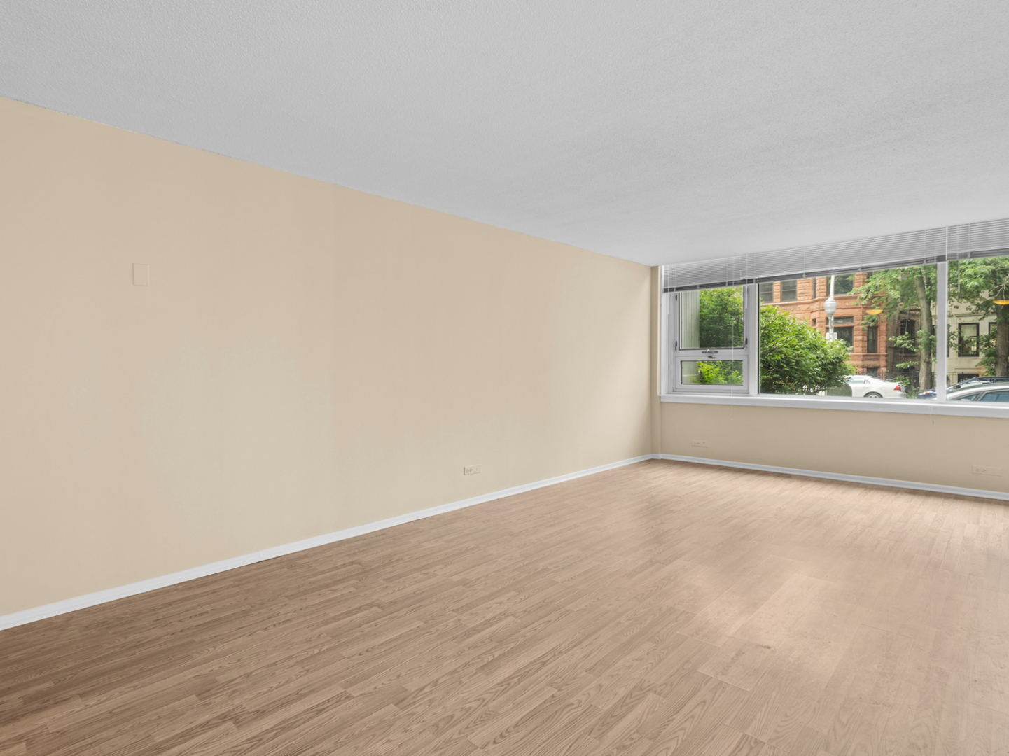 2728 North Hampden Court, Unit 109 Chicago, IL 60614 - Photo 6 of 20 a view of an empty room with wooden floor and a window
