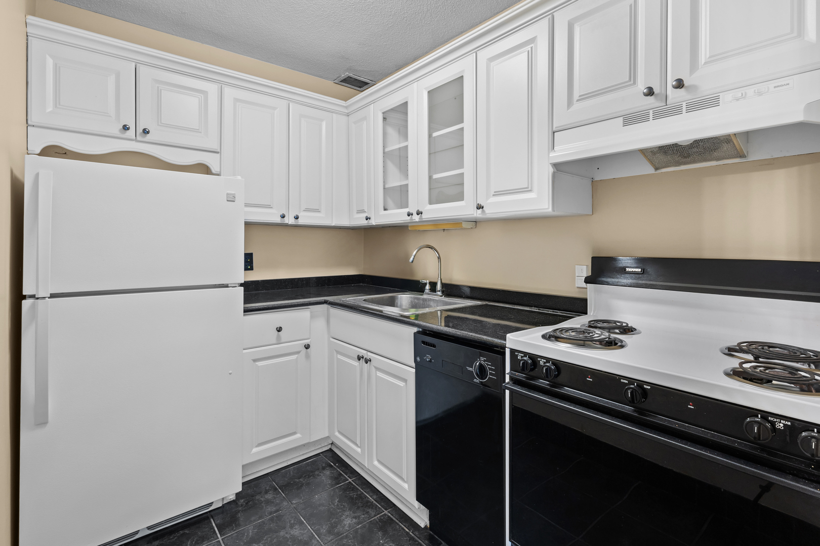 2728 North Hampden Court, Unit 109 Chicago, IL 60614 - Photo 8 of 20 a kitchen with a stove and white cabinets