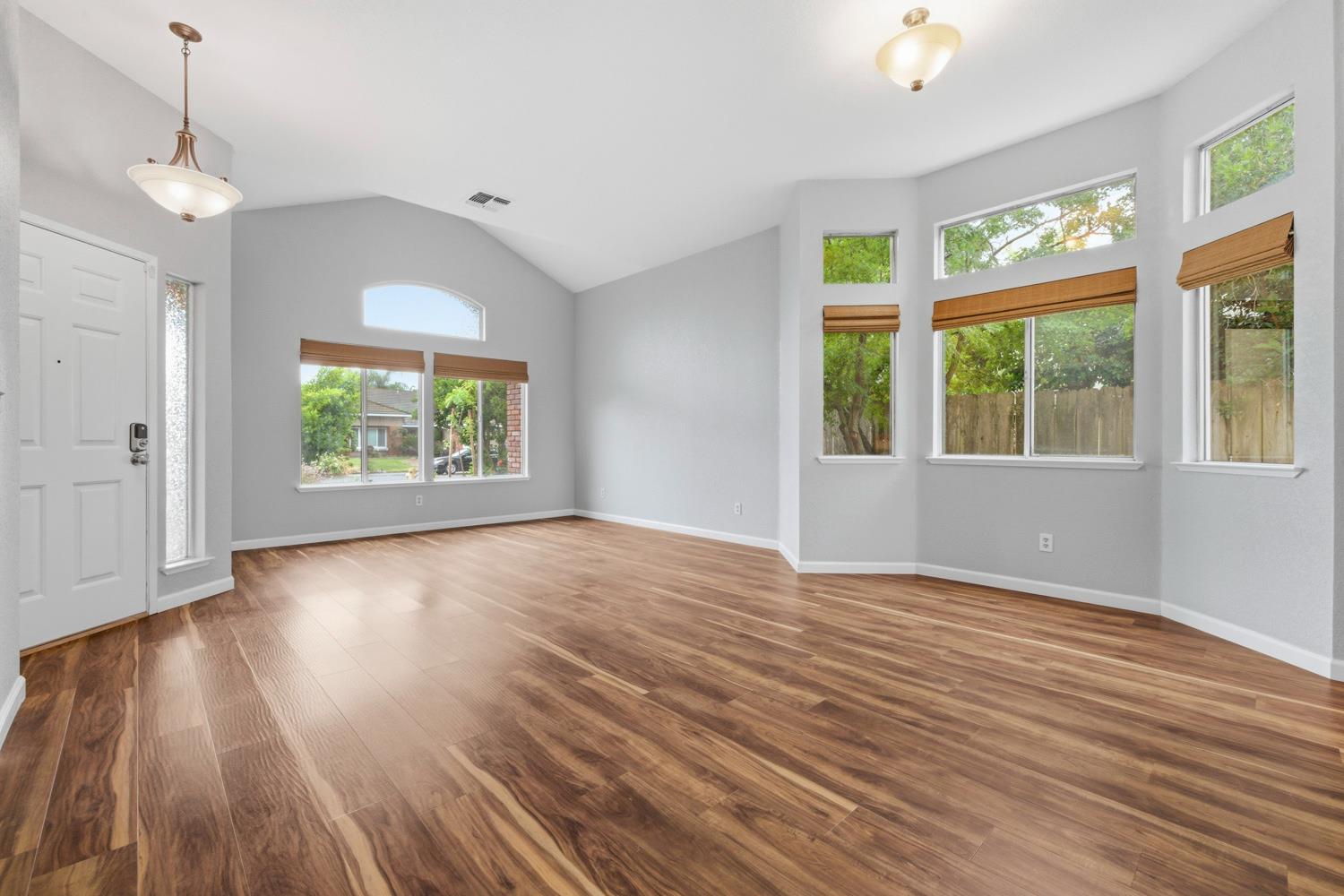 969 Colson Way Galt, CA 95632 - Photo 6 of 38 a view of an empty room with wooden floor and a window