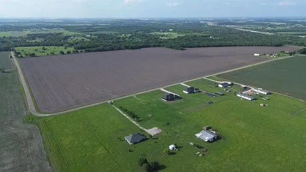 an aerial view of a golf course with huge green field