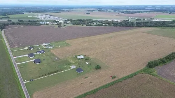 an aerial view of a residential houses with outdoor space and ocean view