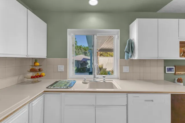 a kitchen with a sink and cabinets