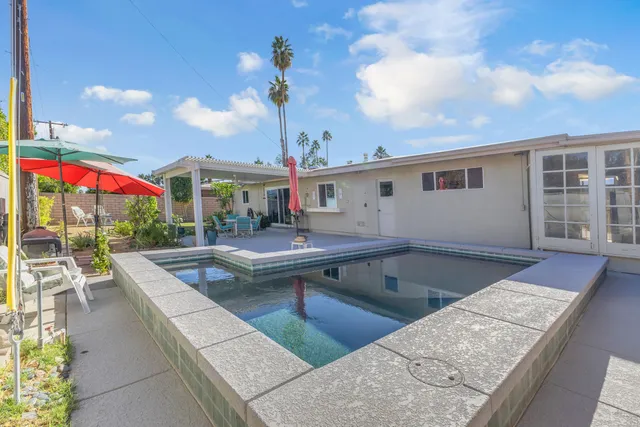 a view of a porch with chairs and backyard