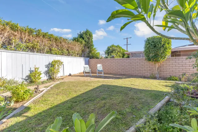 a view of a house with swimming pool and a yard