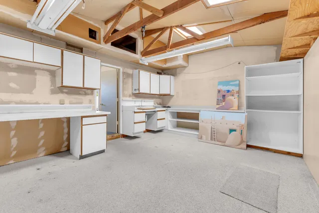 a view of a houses with a yard and a large tree