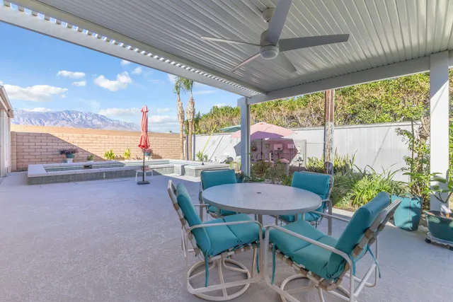 a view of a patio with a table chairs and a patio