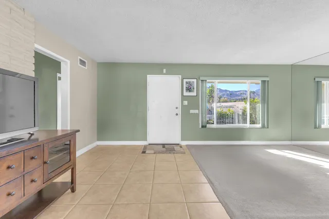 a view of a room with window and cabinet