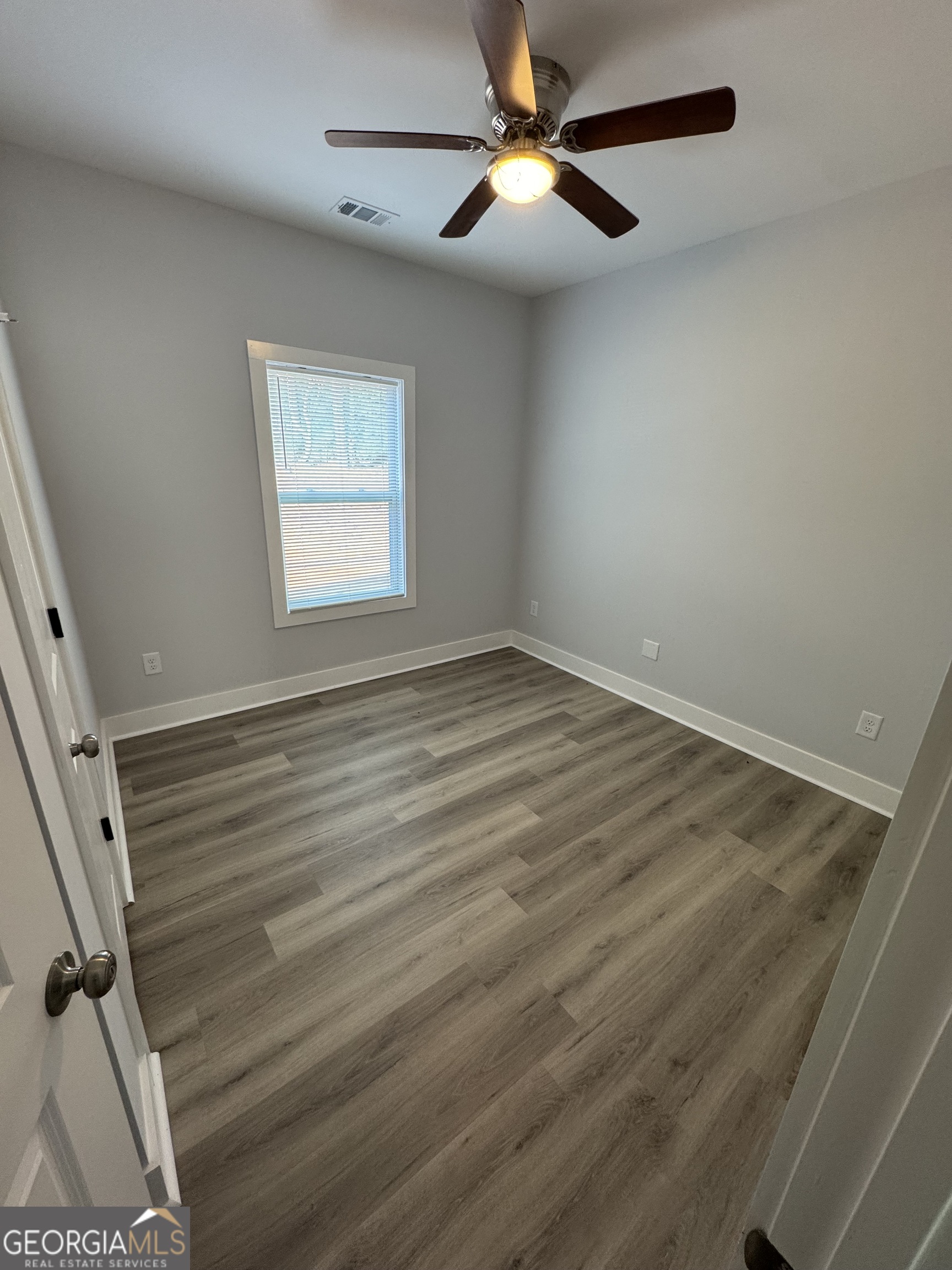 825 Mercer Drive Elberton, GA 30635 - Photo 11 of 16 wooden floor in an empty room with a window