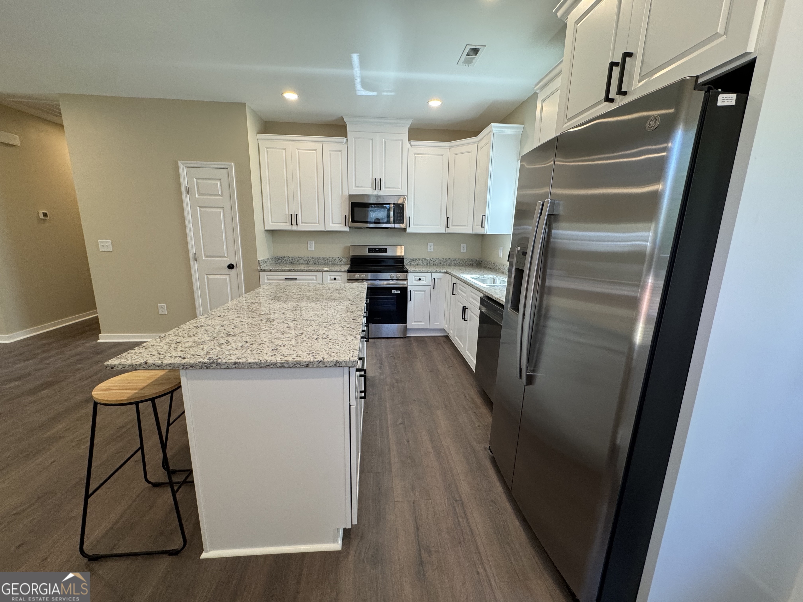 825 Mercer Drive Elberton, GA 30635 - Photo 5 of 22 a kitchen with a refrigerator a sink and cabinets