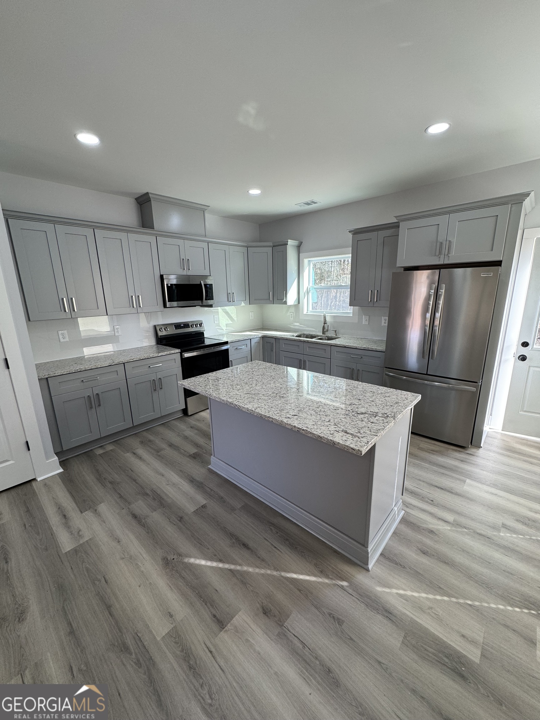 825 Mercer Drive Elberton, GA 30635 - Photo 6 of 16 a large kitchen with a stove a sink dishwasher a refrigerator and a oven