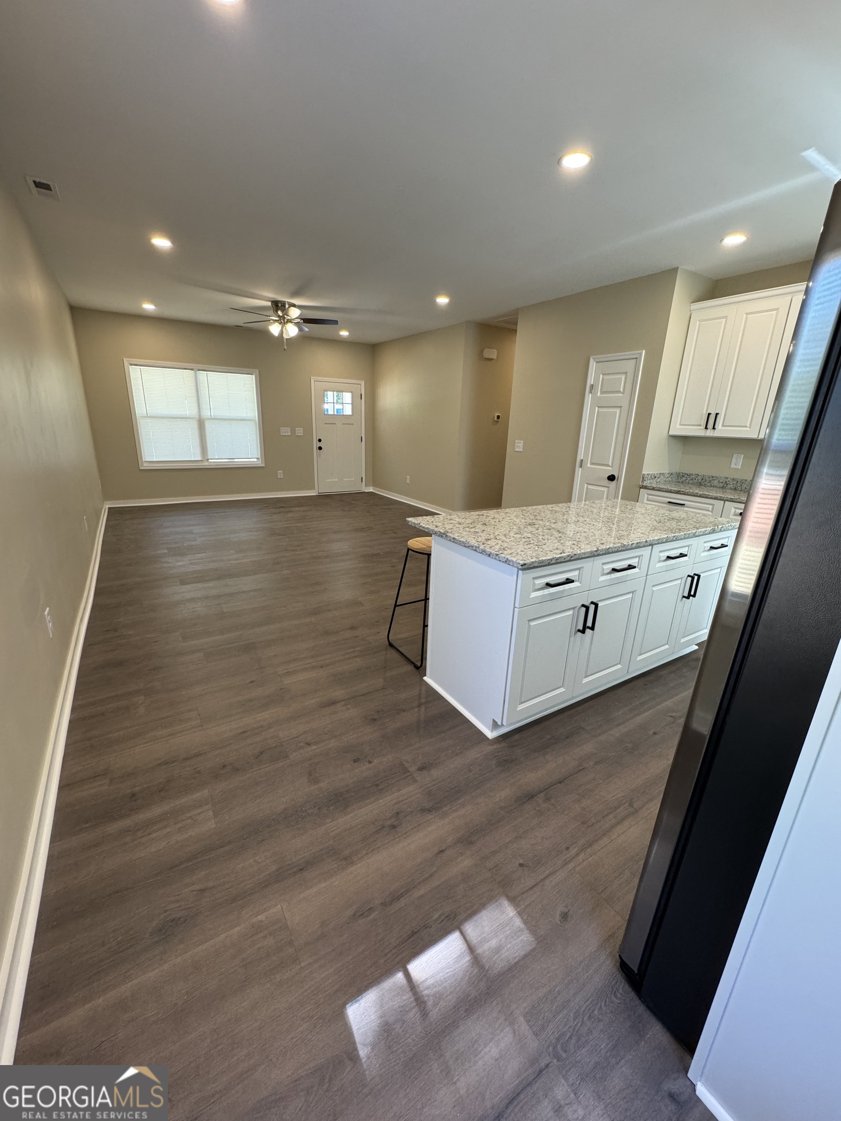 825 Mercer Drive Elberton, GA 30635 - Photo 6 of 22 a large room with kitchen island a sink wooden floor and window