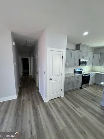 a view of a kitchen with wooden floor