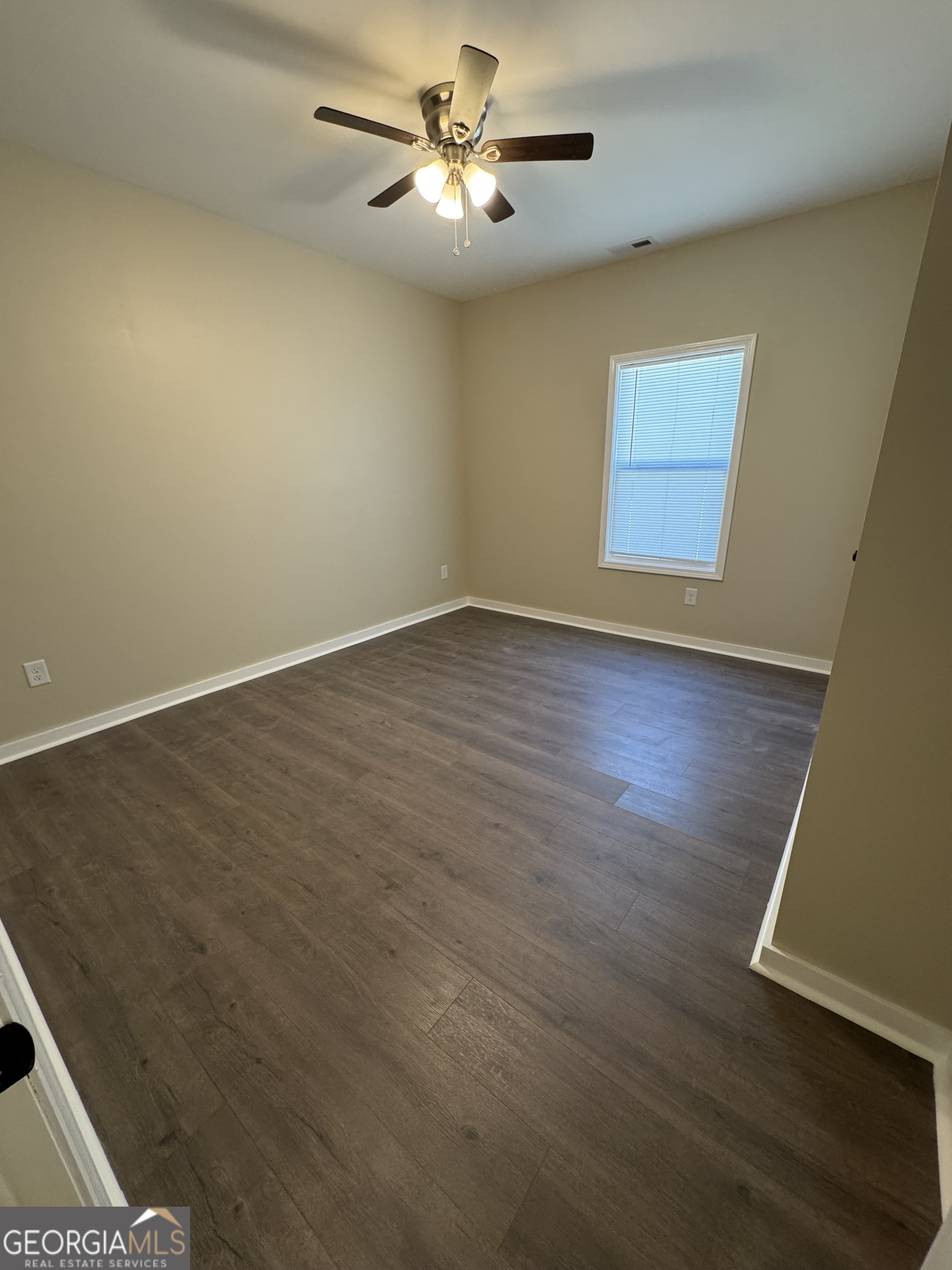 825 Mercer Drive Elberton, GA 30635 - Photo 8 of 22 a view of empty room with wooden floor and fan