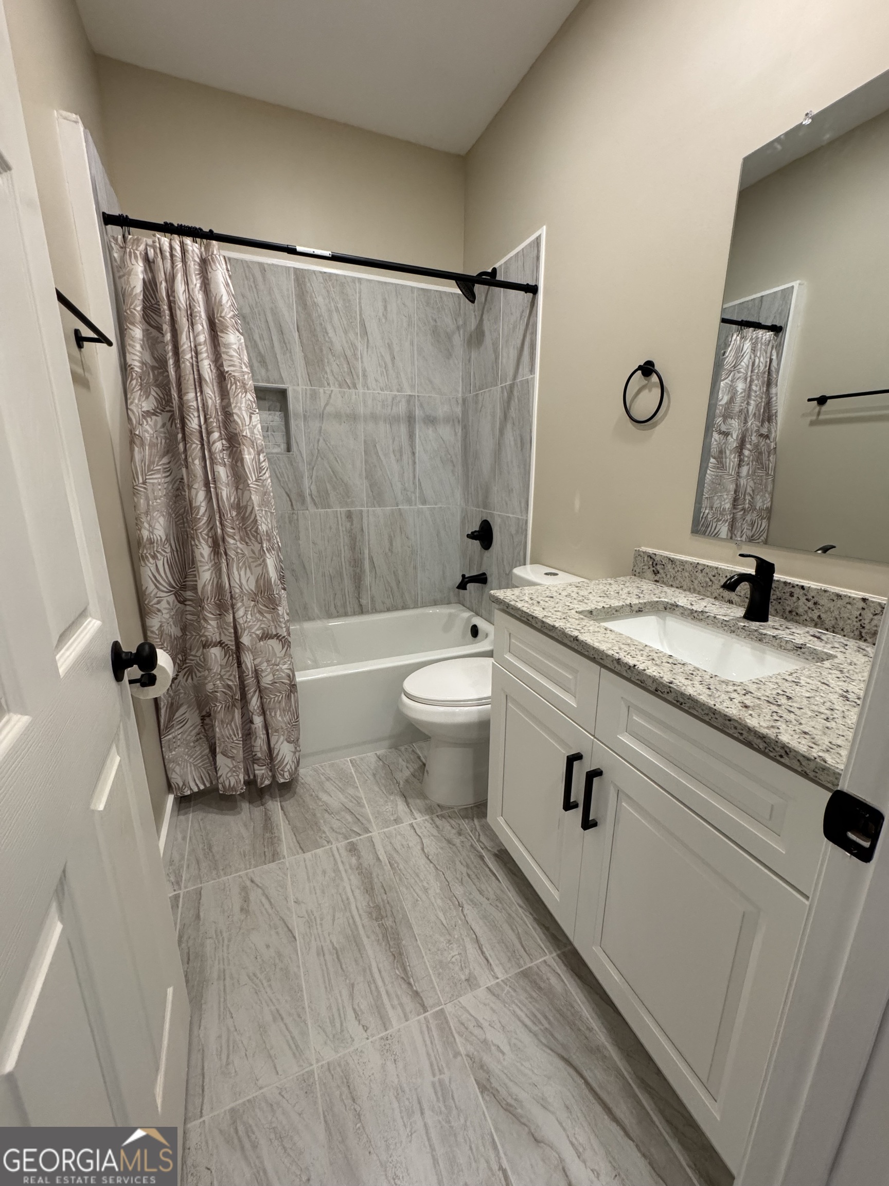 825 Mercer Drive Elberton, GA 30635 - Photo 9 of 22 a bathroom with a granite countertop sink toilet and shower