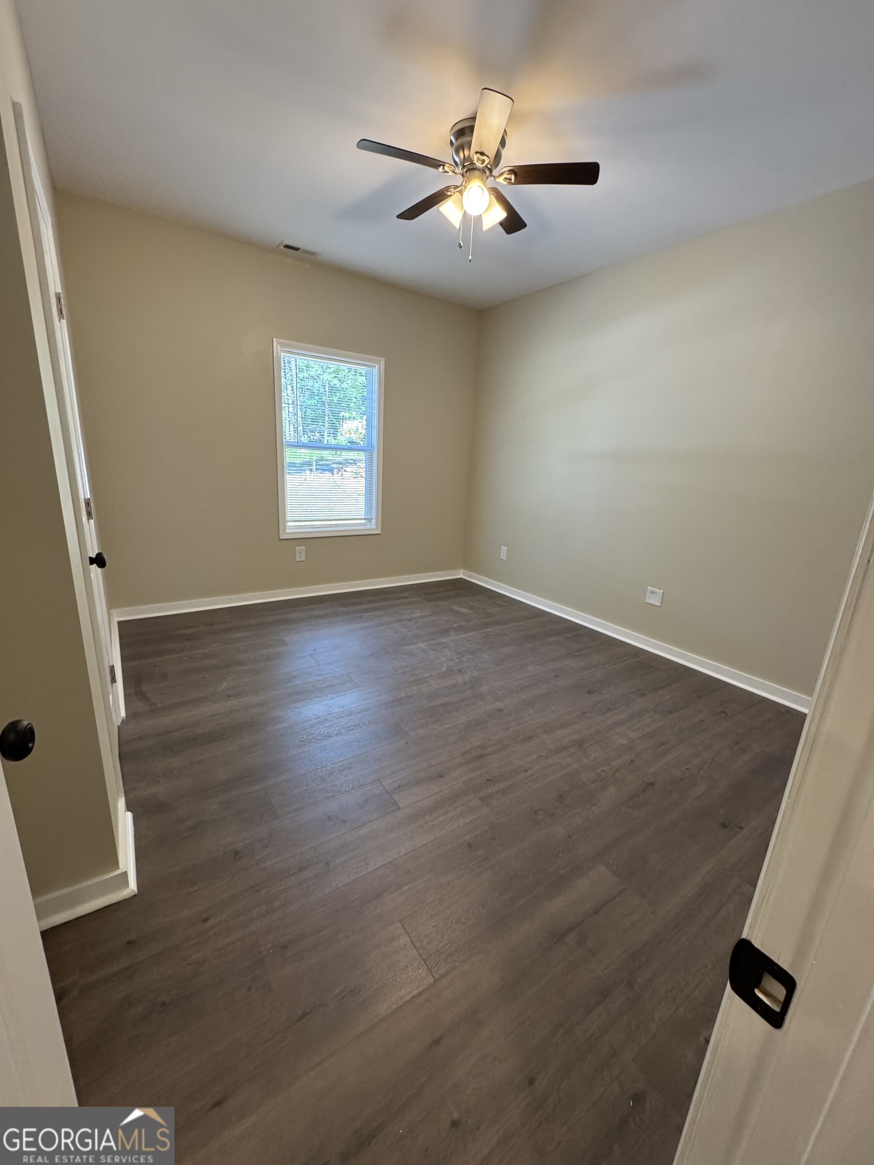 825 Mercer Drive Elberton, GA 30635 - Photo 10 of 22 wooden floor in an empty room with a window