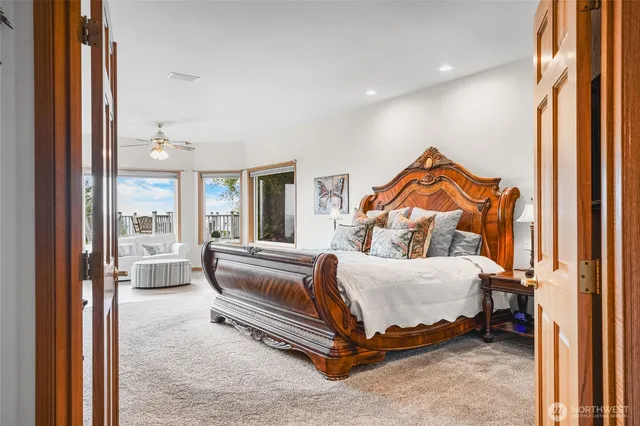 a bedroom with a bed and a large window with outer view