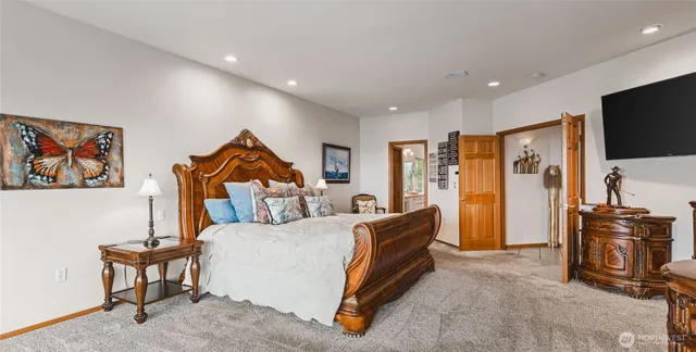 a bedroom with furniture and a flat screen tv