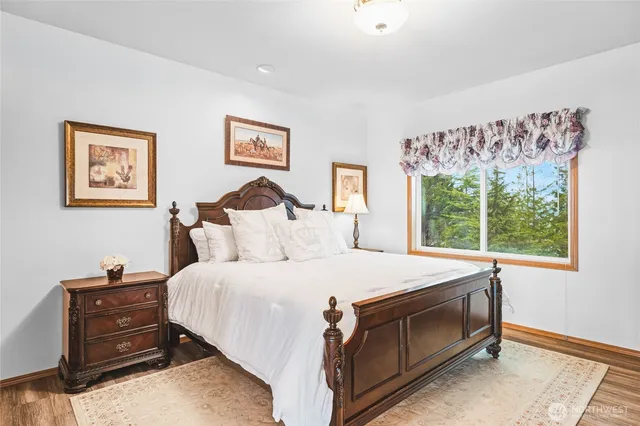 a bedroom with a bed dresser and window