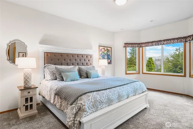 a bedroom with a large bed and a window