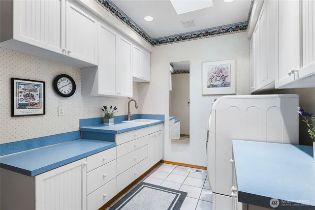 a kitchen with a refrigerator and a sink