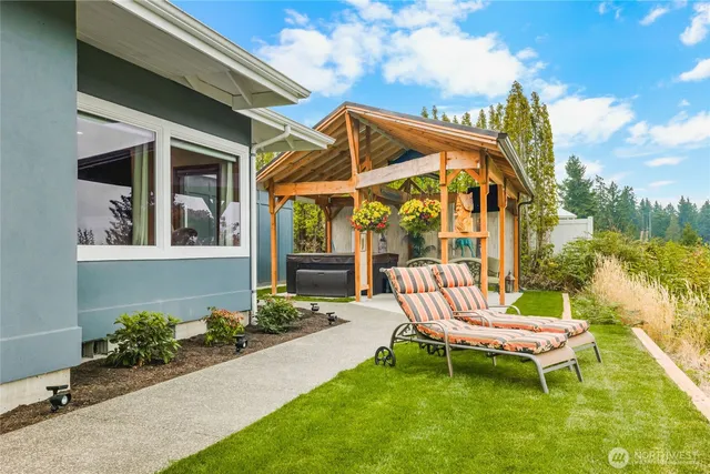 a backyard of a house with table and chairs