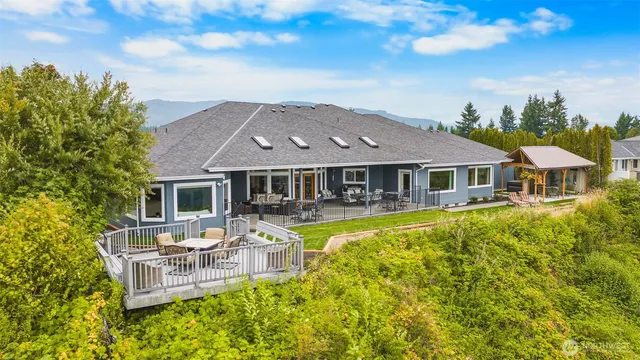 a aerial view of a house with swimming pool and sitting area