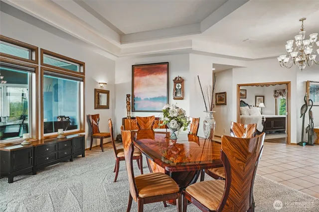 a dining room with furniture a chandelier and wooden floor