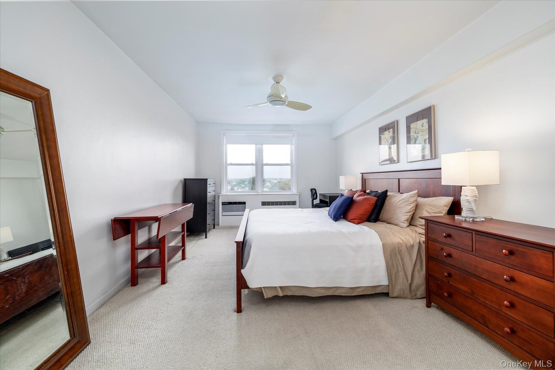 522 Shore Road, Unit 5P Long Beach, NY 11561 - Photo 13 of 28 a spacious bedroom with a bed and a dresser in it